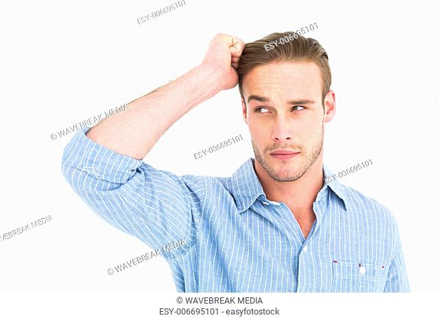 Handsome man in shirt thinking with hand on head