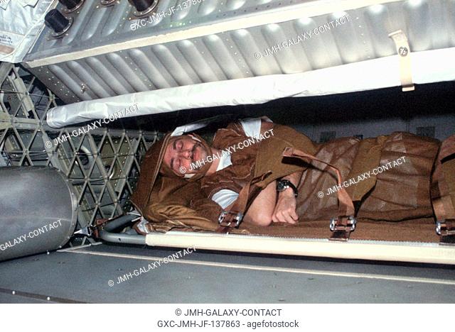 View of scientist-astronaut Owen K. Garriott, Skylab 3 science pilot, in his sleep restraints in the crew quarters of the Orbital Workshop (OWS)