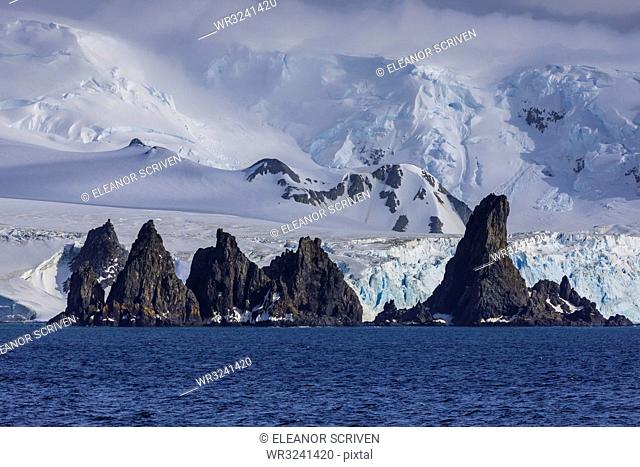 Pinnacle rocks, glaciers, mountains of Greenwich Island, from the sea, bright, misty weather, South Shetland Islands, Antarctica, Polar Regions