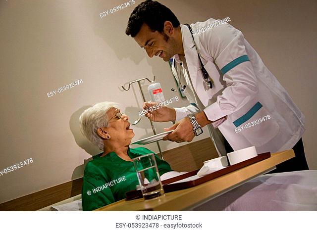 Doctor feeding his patient