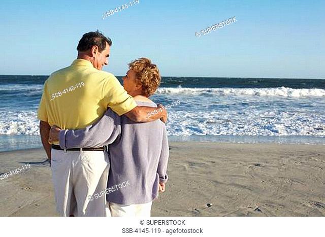 Couple standing on the beach, Far Rockaway, Queens, New York City, New York State, USA