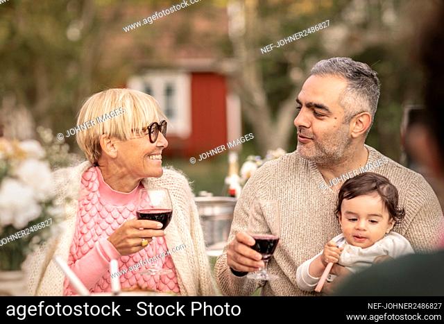 Man and woman having wine in garden