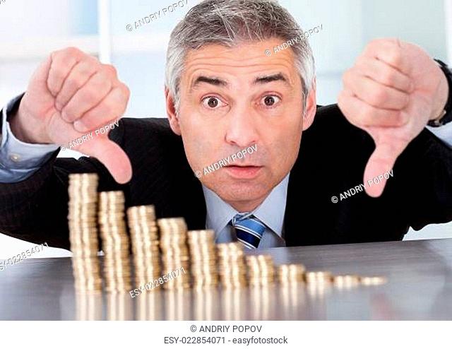Shocked Businessman With Stack Of Coins