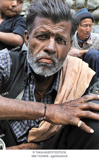 Man sitting at the shppong street in New Manali. Manali, Himachal Pradesh, India