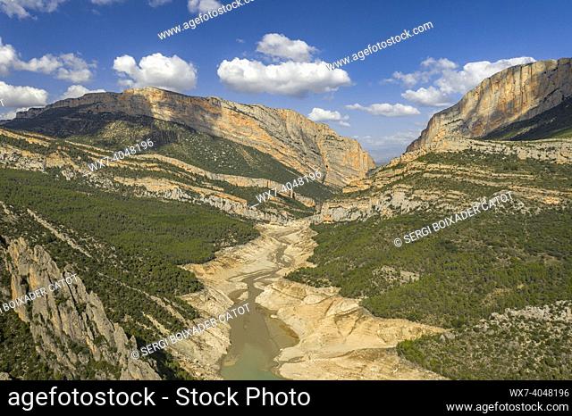Canelles reservoir almost empty during the 2022 drought in front of the Montsec range and the Mont-rebei gorge (La Noguera, Lleida, Catalonia, Spain, Pyrenees)