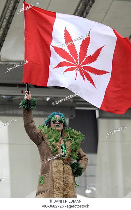 Woman wearing marijuana leaf sunglasses and waves a Canadaian 'pot flag' during the annual 420 Smoke Out at Yonge-Dundas Square in Toronto, Ontario, Canada