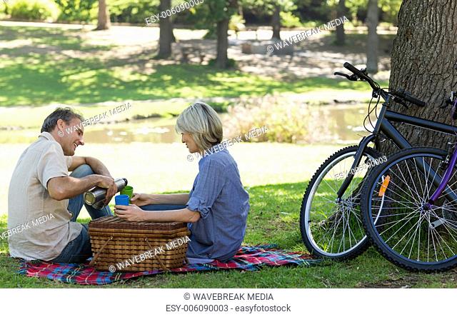 Couple enjoying coffee in park