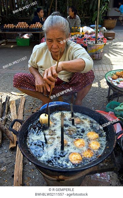 old woman frying snacks at the market, Laos, Luang Prabang