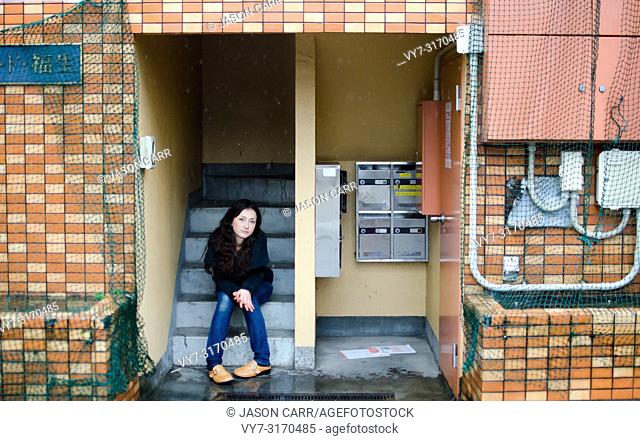 Japanese Girl poses on the street in Fussa, Japan. Fussa is a city located in Tokyo