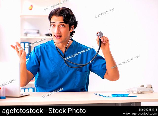 Young handsome doctor working at the clinic