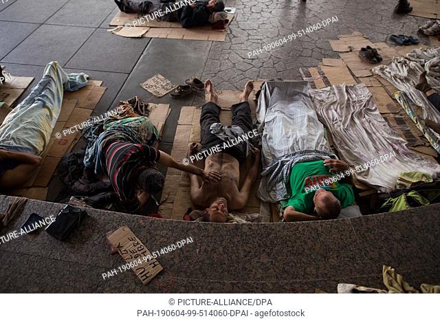 04 June 2019, Venezuela, Caracas: Former oil workers lie in a camp where they want to draw attention to themselves with a hunger strike