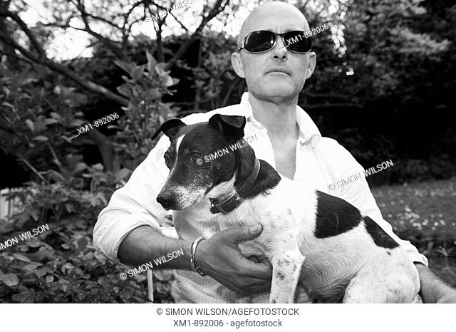Man with sunglasses and Jack Russell dog