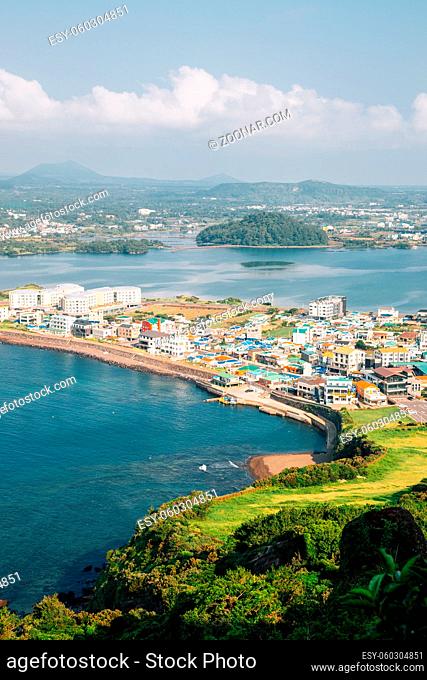 Panoramic view of seaside village from Seongsan Ilchulbong Tuff Cone in Jeju Island, Korea
