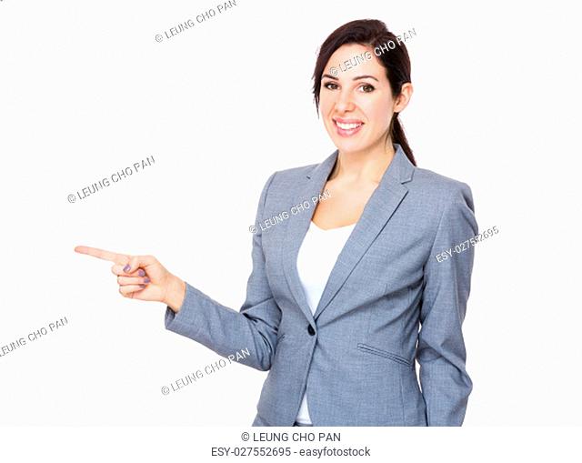 Confident businesswoman with finger indicate aside