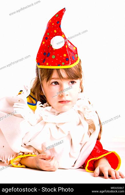 little girl wearing a clowns costume