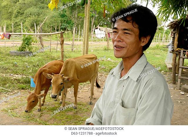 CAMBODI  A  Sin Vorn 32 owner of two cows and beneficiary of DPA animal husbandry project, Ban Bung village, Stung Treng district