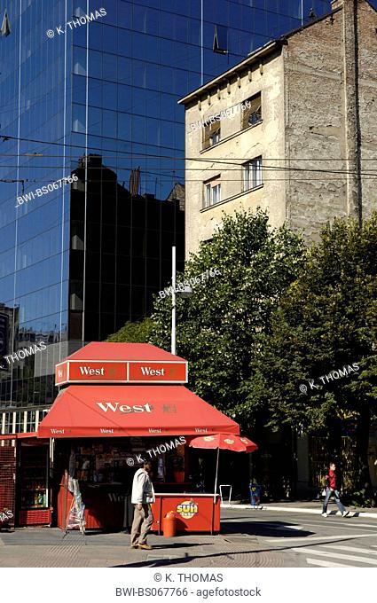 old building falling apart next to a modern building with glass facade, contradiction, red kiosk with West logo, Serbia-Montenegro, Belgrade
