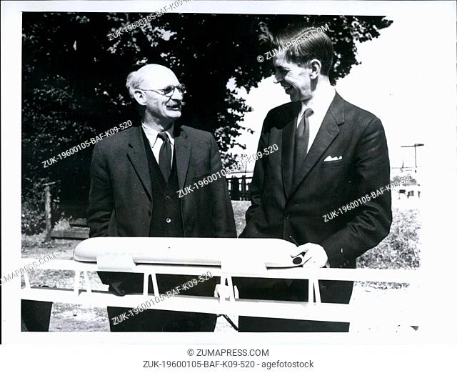 1963 - Christopher Cockerell (left), discusses his latest project, a Hovertrain, with engineer Alan Pennington as they stand by a model of the train at...
