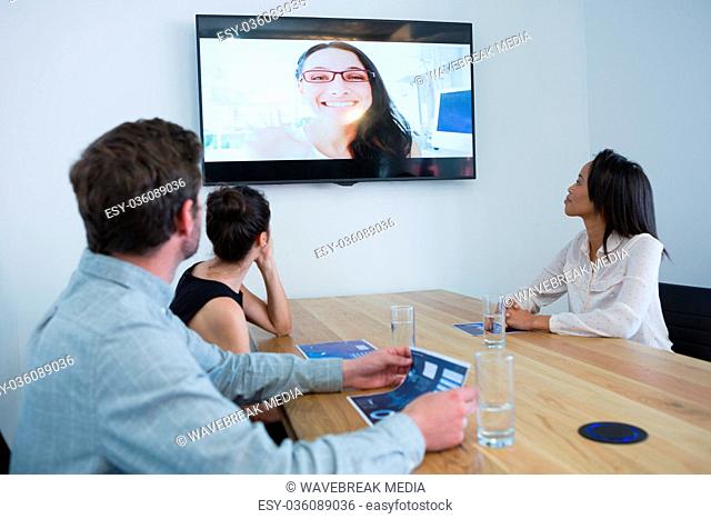 Business colleagues attending a video call in conference room