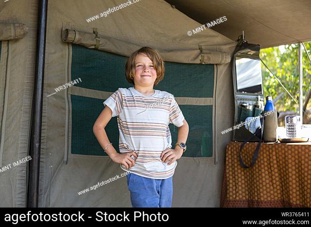 Portrait of young boy in tent, Okavango Delta, Botswana