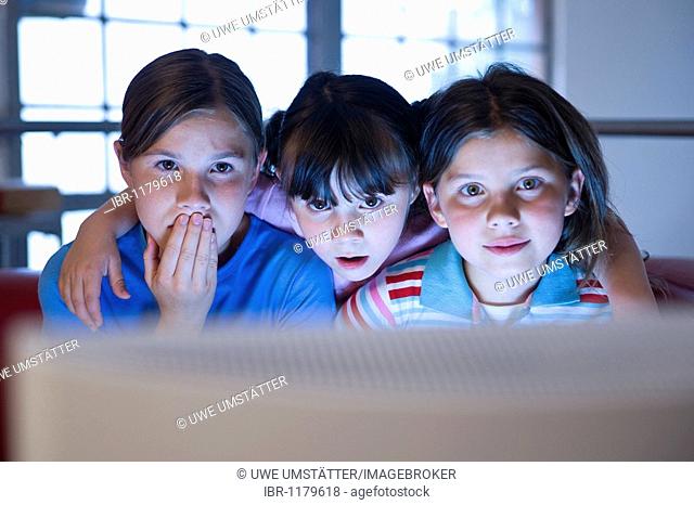 Three girls looking fascinated at a screen