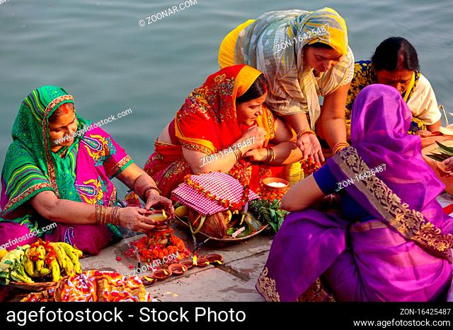Unidentified Indian women pray and devote for Chhath Puja festival on Ganges river side in Varanasi, India