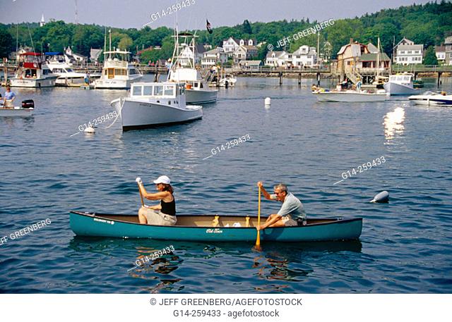 Couple in canoe during Windjammer Days annual event. Boothbay Harbor, Lincoln County. Maine. USA