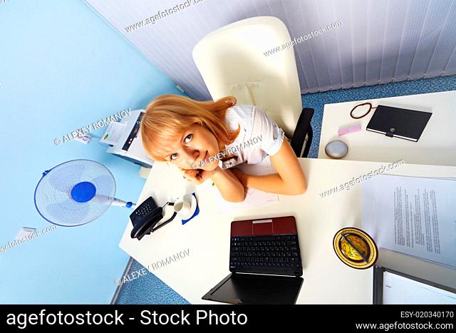 Funny young woman sitting in an office