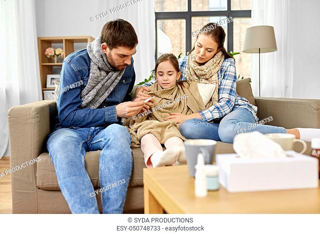 family with ill daughter having fever at home