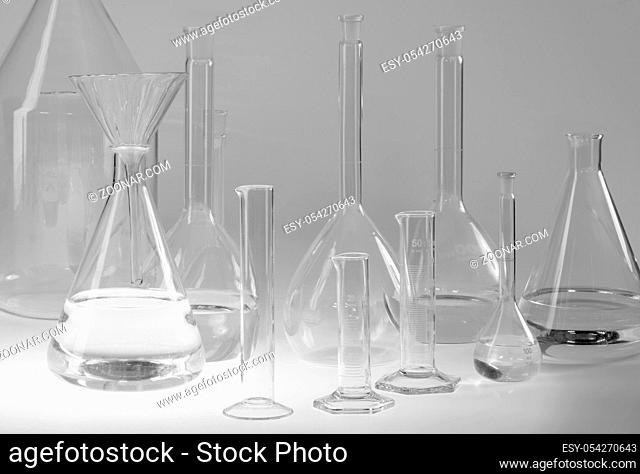 variety of partly filled laboratory glassware