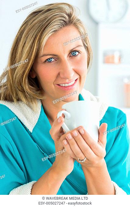 Smiling woman in dressing gown looking directly into the camera