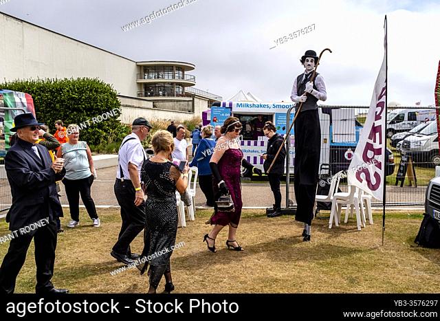 People Dressed In Period Costume Arrive At The Great Gatsby Fair, Bexhill on Sea, East Sussex, UK
