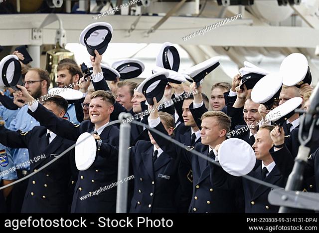 08 August 2022, Schleswig-Holstein, Kiel: Crew members of the ""Gorch Fock"" wave during the departure. The sail training ship set off on a training voyage on...