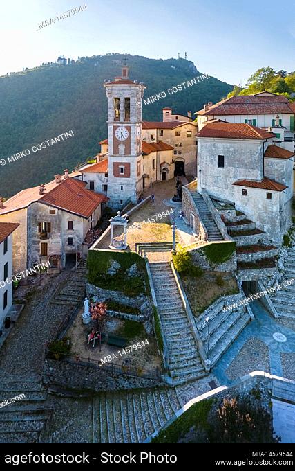 Aerial view of Santa Maria del Monte and the chapels of the sacred way during a summer sunset. Sacro Monte di Varese, Varese, Lombardy, Italy