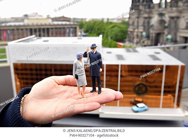 A miniature model of the Palace of the Republic with a model of a Trabant and figurines of Margot and Erich Honecker on a viewing platform looking out onto the...