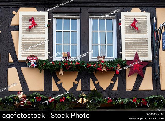 windows and wooden houses in colmar, alsace, decorated for christmas