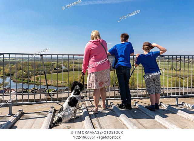 A woman with her two boys admire the view from the top of the church tower in Beccles , Suffolk , England , Britain , Uk
