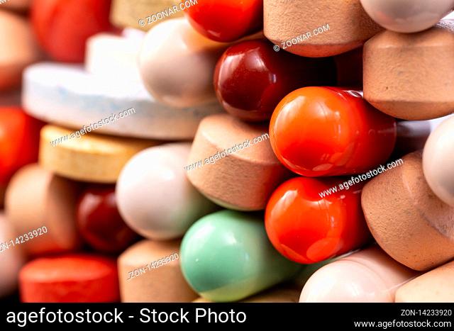 Different colorful pills and capsules stacked. Global pharmaceutical industry for billions dollars per year. Pharmaceutical drugs for use as medications