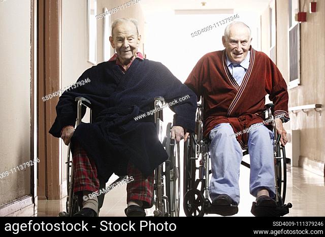 Elderly men racing in wheelchairs