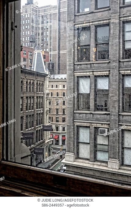 Looking out the window of a Flat Iron building at the Flatiron District of New York City, on a Rainy Day