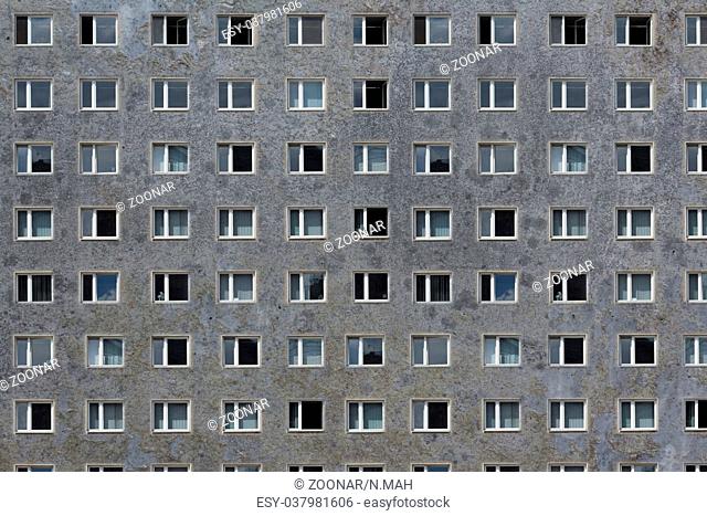 many windows on grey building facade - plattenbau