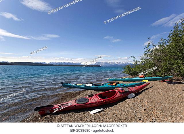 Sea kayaks on the shore of Atlin Lake, British Columbia, Canada, America