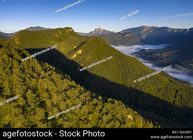 Aerial view of the Falgars sanctuary and the Catllaras s mountain range at sunrise with fog in the Lillet valley (Berguedá , Barcelona, Catalonia, Spain)