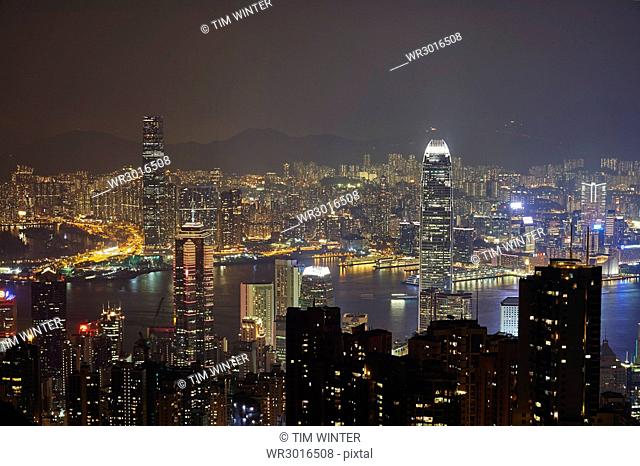 View at night of central Hong Kong and Victoria Harbour from Victoria Peak, looking toward Kowloon in background, Hong Kong, China, Asia