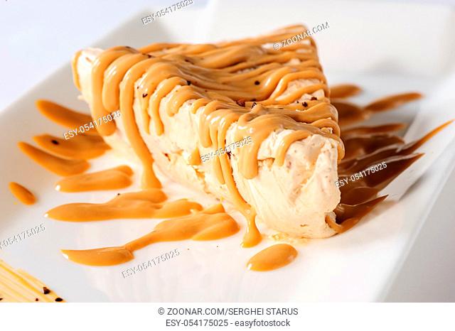 Delicious frozen cheesecake with caramel and sweet condensed milk topping