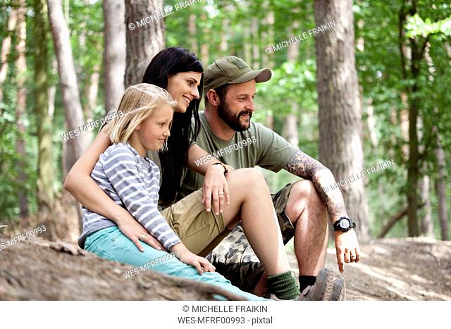 Happy family with daughter in forest