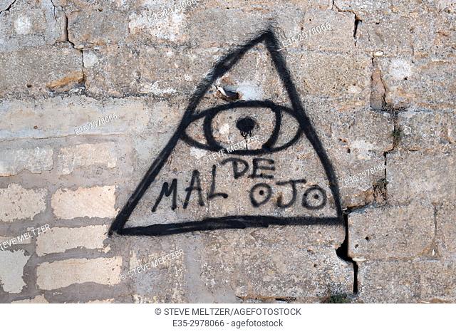 A graffiti ""evil eye"" painted by a gypsy on a wall in the South of France