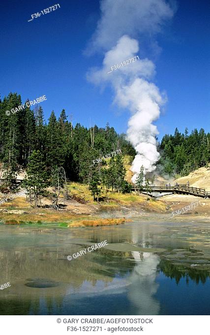 Tourists watch steam rise from Dragon's Mouth Spring, by Mud Caldron, Yellowstone National Park, WYOMING