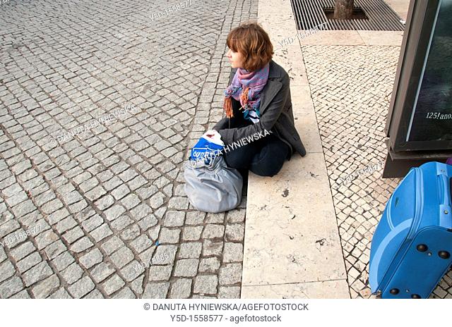 young woman waiting for the bus in Lisbon, Portugal