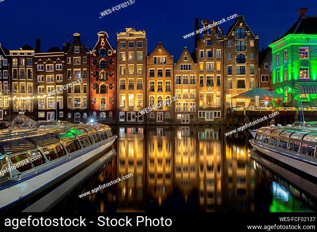 Netherlands, North Holland, Amsterdam, ¶ÿRow of townhouses along canal at night